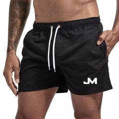 Quick drying, mid-length beach shorts Black Beachwear Australia